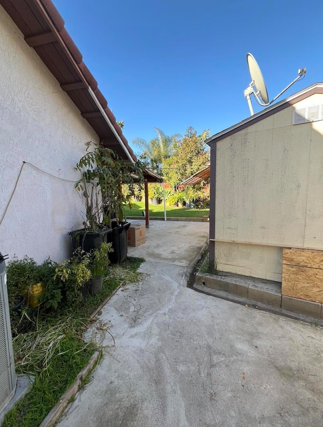 view of side of home with a patio