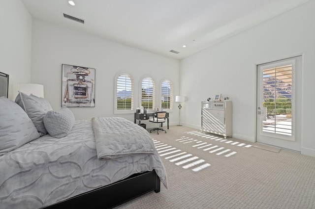 bedroom with light colored carpet and access to exterior