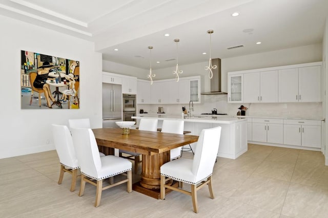 tiled dining area featuring sink