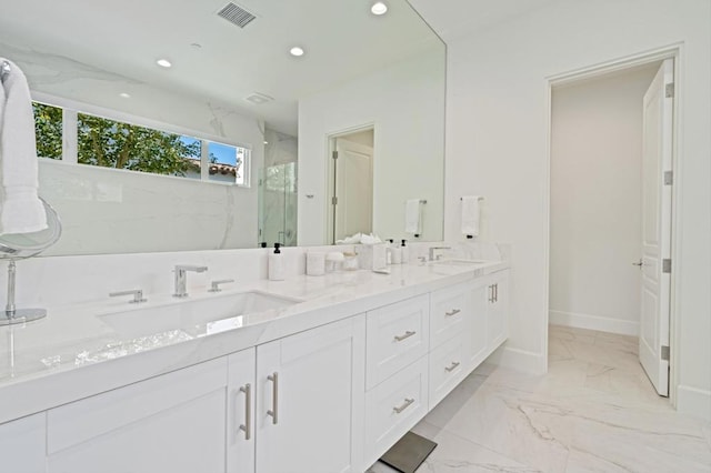 bathroom with walk in shower and vanity