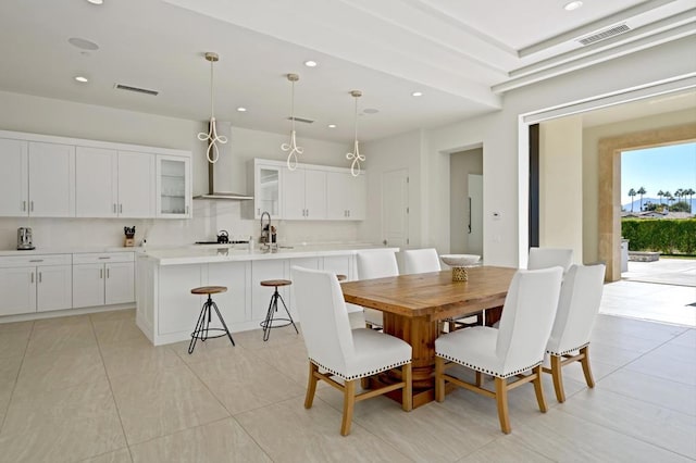 dining room featuring light tile patterned flooring and sink