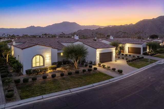 view of front of property with a garage and a mountain view