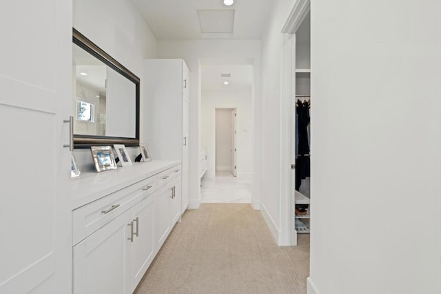 hallway featuring light colored carpet