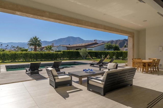 view of patio / terrace with a mountain view and a fenced in pool