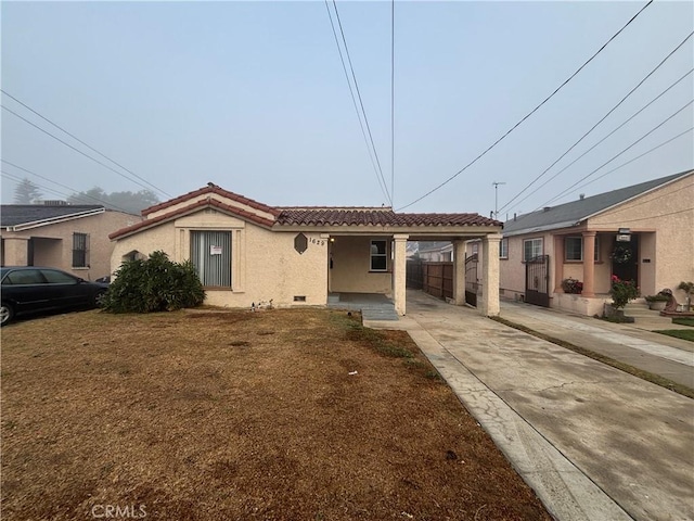 view of front of house with a front lawn and a carport