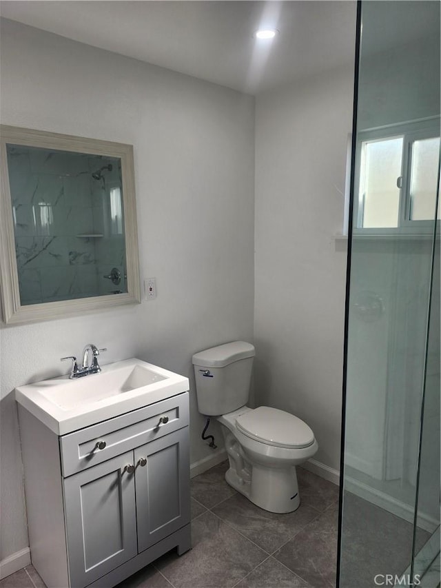 bathroom featuring toilet, tile patterned flooring, and vanity