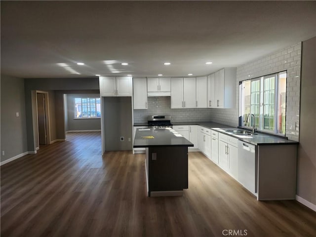 kitchen featuring a kitchen island, sink, white cabinetry, stainless steel range oven, and dishwashing machine