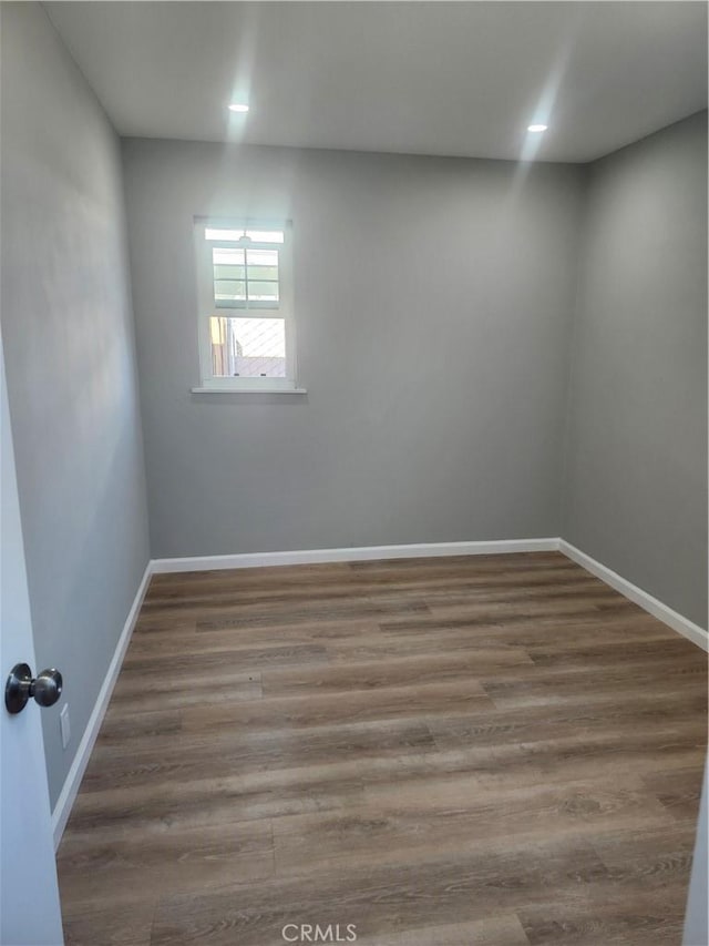 unfurnished room with wood-type flooring