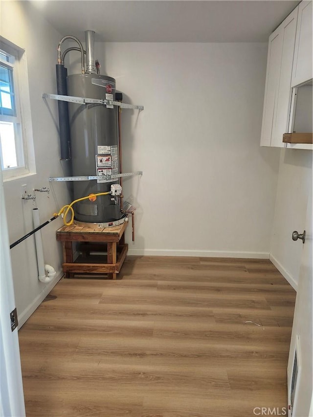 utility room featuring secured water heater