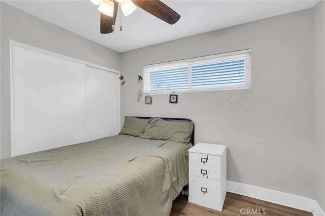 bedroom featuring ceiling fan, a closet, and hardwood / wood-style floors