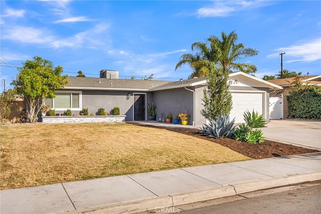 ranch-style home with a front lawn and a garage