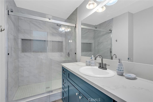 bathroom featuring walk in shower and vanity