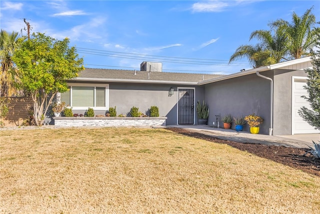 exterior space with a garage and a front lawn