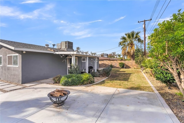 view of patio / terrace with central AC unit and a fire pit