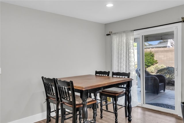 dining space with hardwood / wood-style flooring