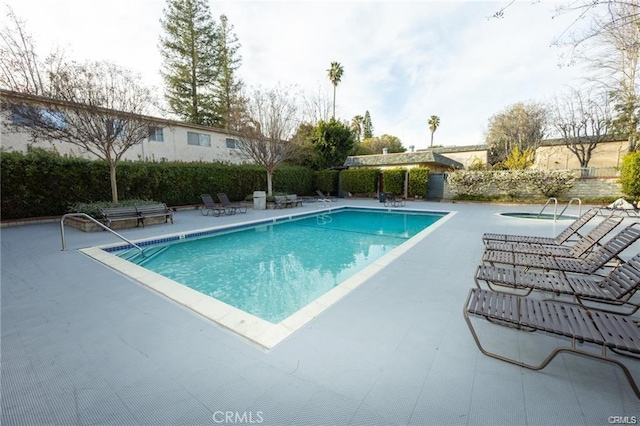 view of swimming pool with a patio