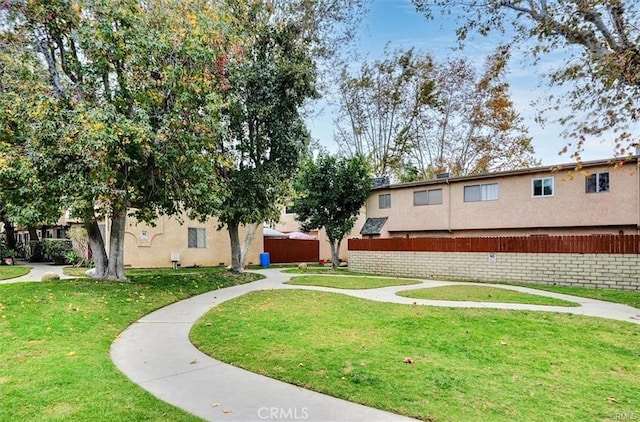 view of home's community with a yard