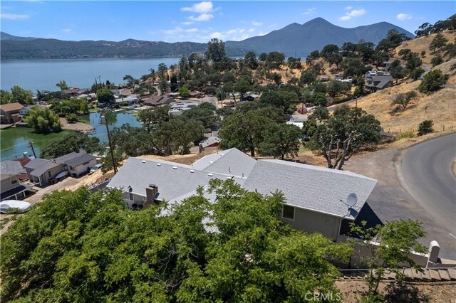 birds eye view of property with a water and mountain view