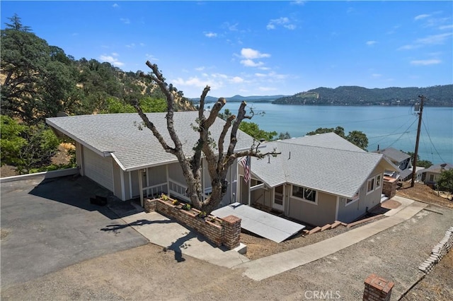 drone / aerial view featuring a water and mountain view