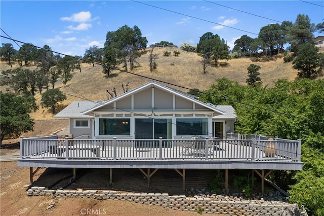 back of property featuring a wooden deck