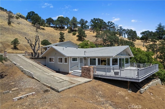 back of property with a wooden deck