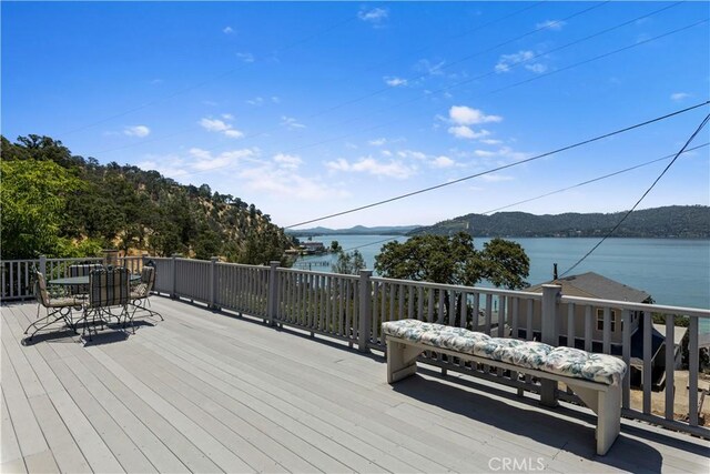 wooden deck featuring a water and mountain view