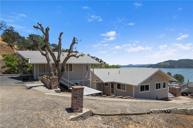 ranch-style house featuring a water view