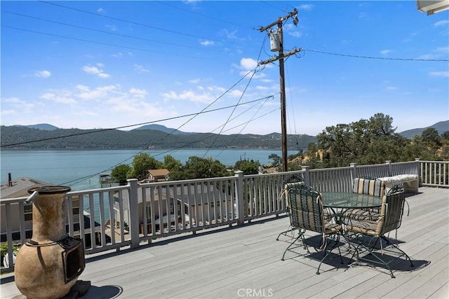 wooden deck featuring a water and mountain view