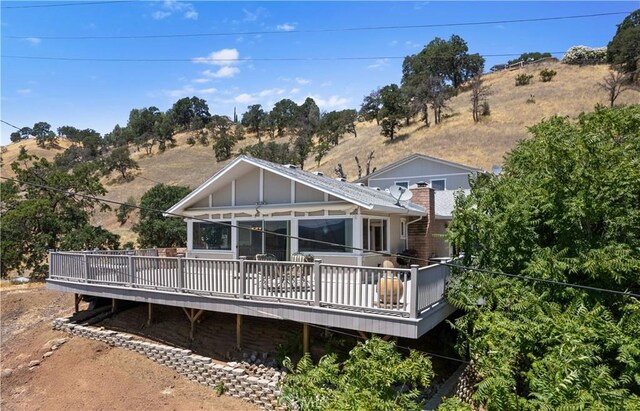 back of house with a wooden deck