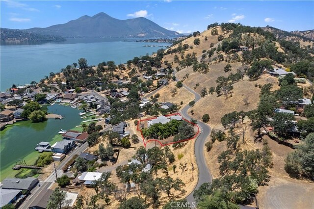 birds eye view of property with a water and mountain view