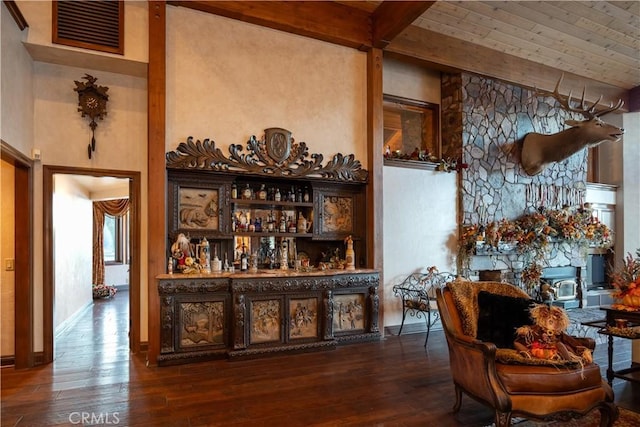 bar featuring wood-type flooring and beamed ceiling