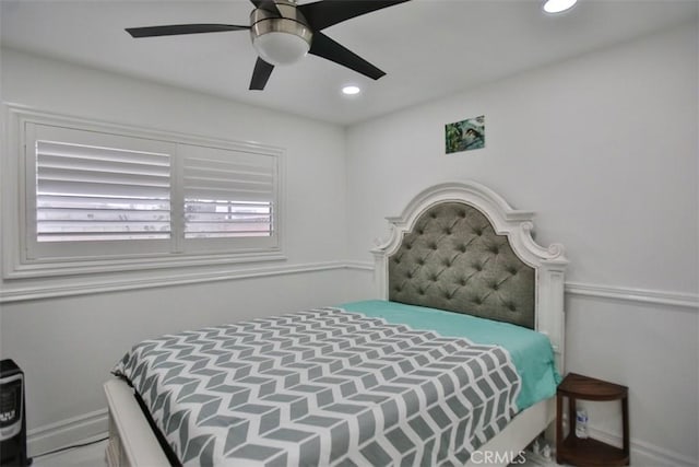 bedroom featuring ceiling fan and multiple windows