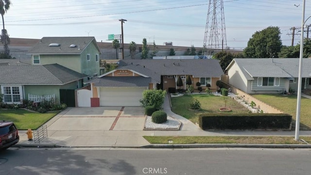 view of front of house featuring a front yard and a garage