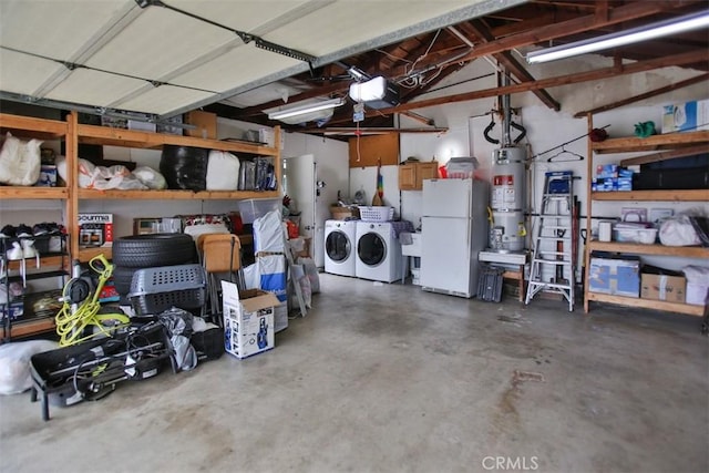 garage with water heater, a garage door opener, white refrigerator, and washer and clothes dryer