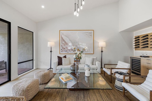 living room featuring vaulted ceiling and beverage cooler