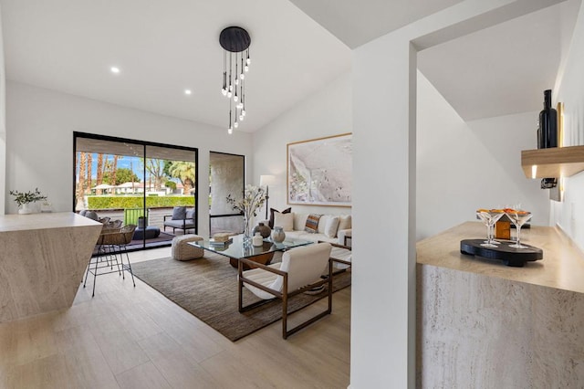 living room with vaulted ceiling and light hardwood / wood-style floors