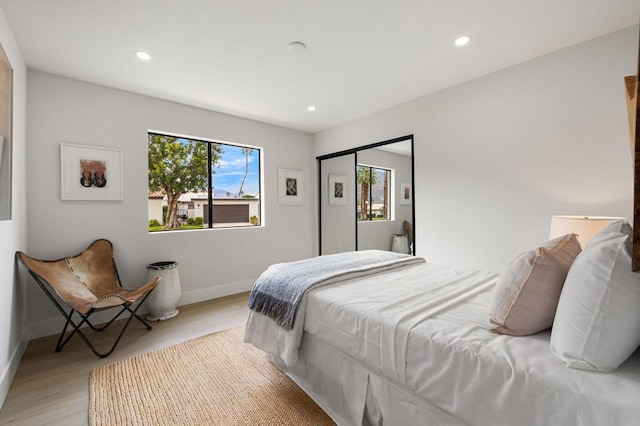 bedroom featuring light hardwood / wood-style floors and a closet