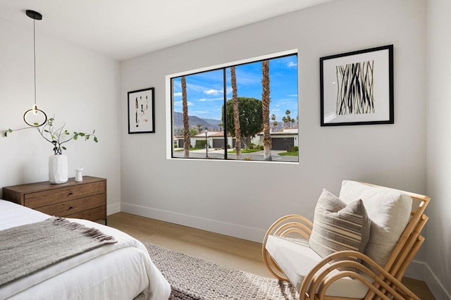 bedroom featuring a mountain view and hardwood / wood-style floors