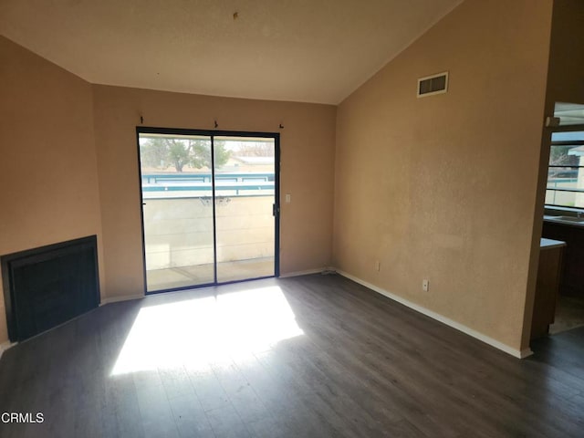 unfurnished living room featuring dark hardwood / wood-style floors and lofted ceiling