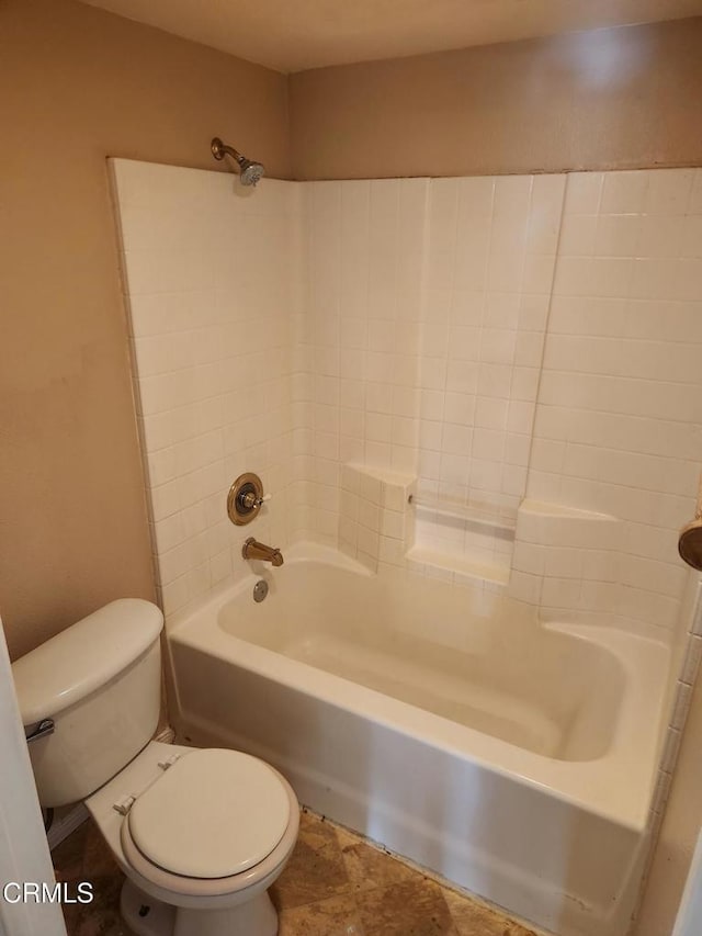 bathroom with shower / bathing tub combination and toilet