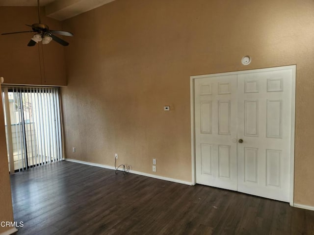 empty room featuring ceiling fan, dark hardwood / wood-style flooring, and lofted ceiling