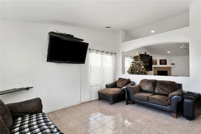 living room with ceiling fan and lofted ceiling