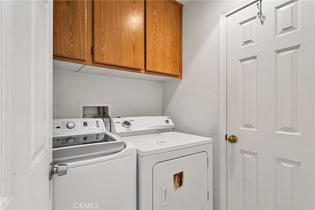 laundry area with cabinets and independent washer and dryer