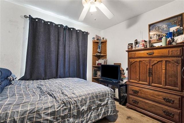 bedroom featuring ceiling fan and light carpet