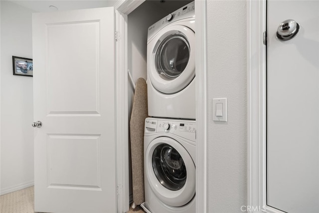 laundry room with stacked washer / drying machine