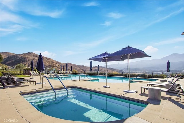 view of pool featuring a mountain view and a patio