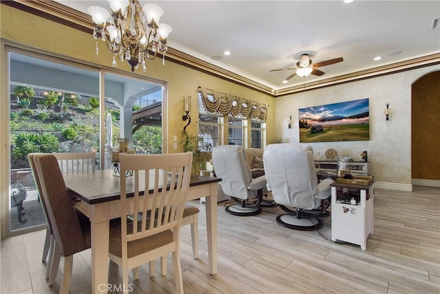 dining area featuring crown molding and ceiling fan with notable chandelier