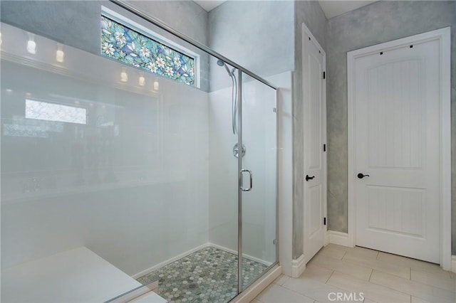 bathroom featuring walk in shower and tile patterned flooring