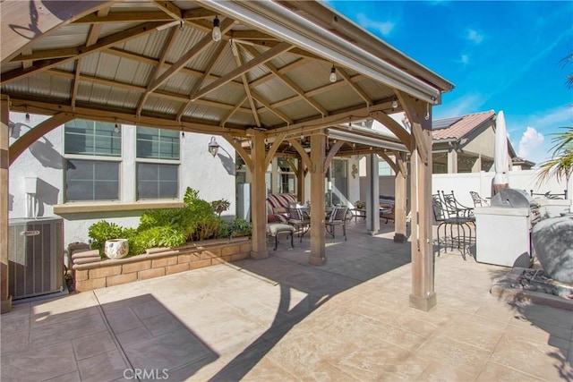 view of patio / terrace with central air condition unit and a gazebo