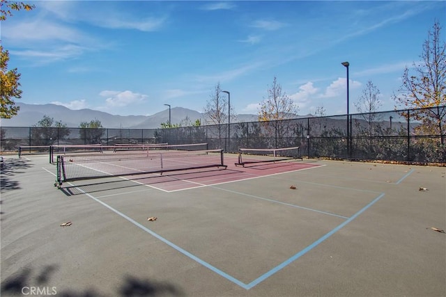 view of sport court with basketball court and a mountain view